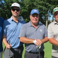 Four golfers posing